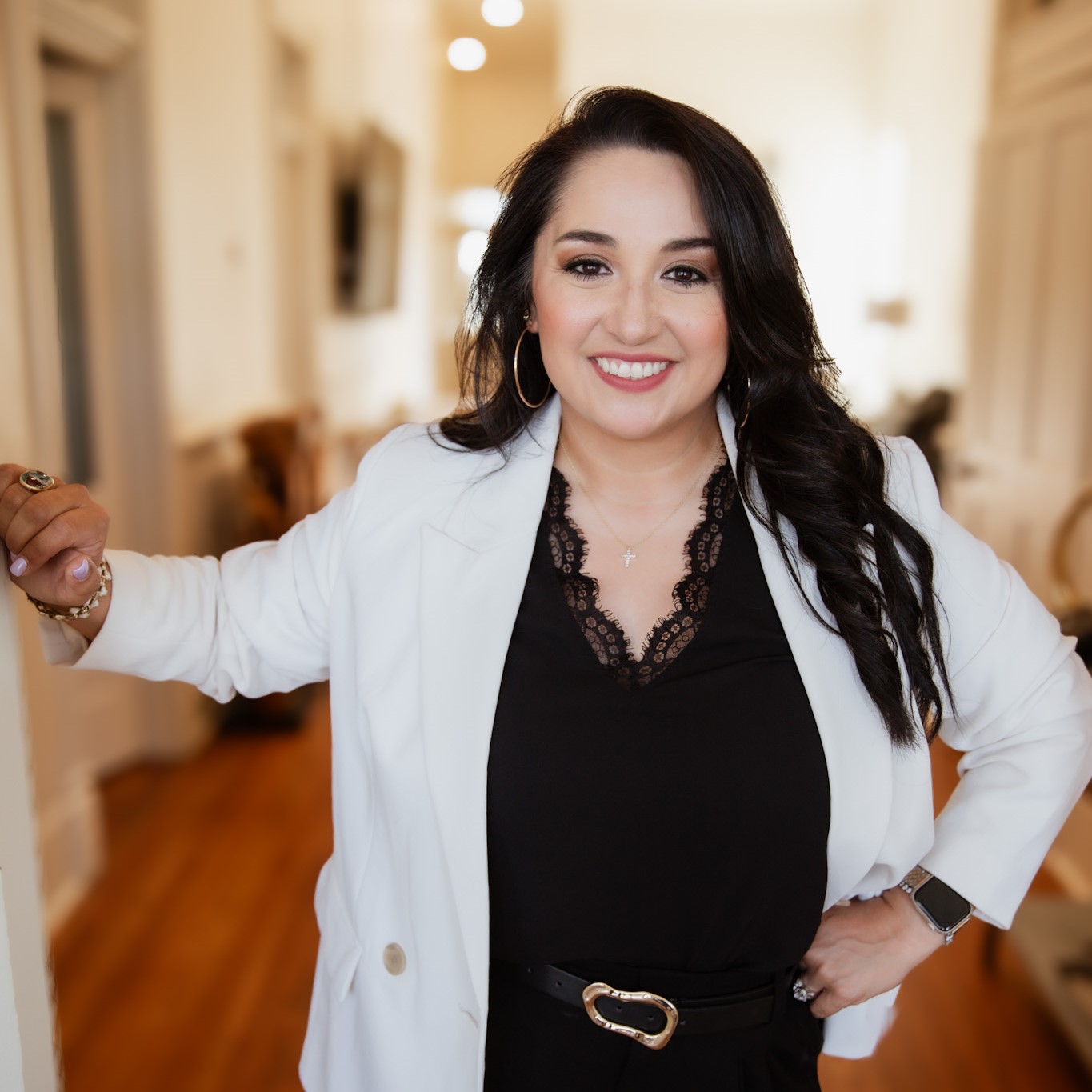 AngelicaHoward1 Angelica Howard, loan officer at American Liberty Mortgage, smiling in a professional setting, wearing a white blazer and black top, emphasizing her commitment to personalized mortgage solutions and client goals.